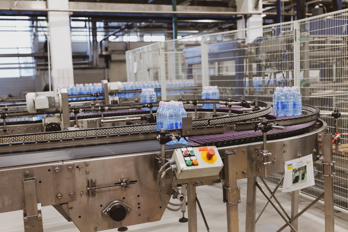 Automated packaging conveyor system with control buttons in modern factory