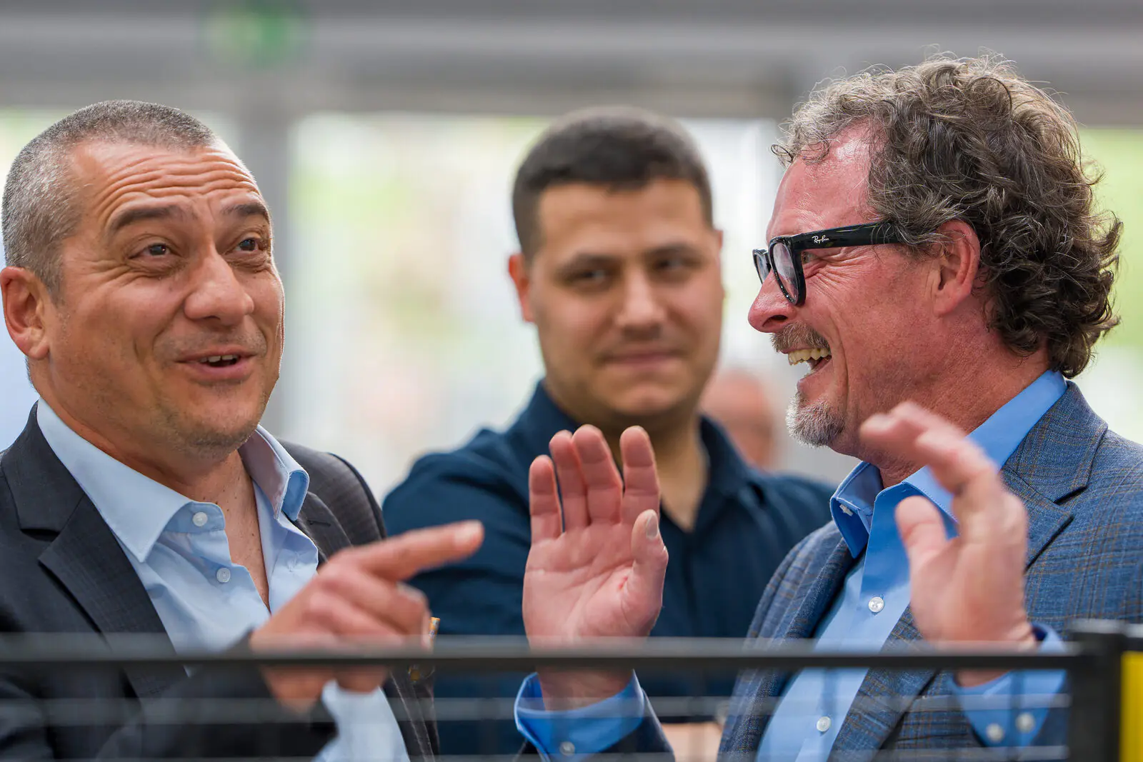 Candid moment between Newlong team members and visitors