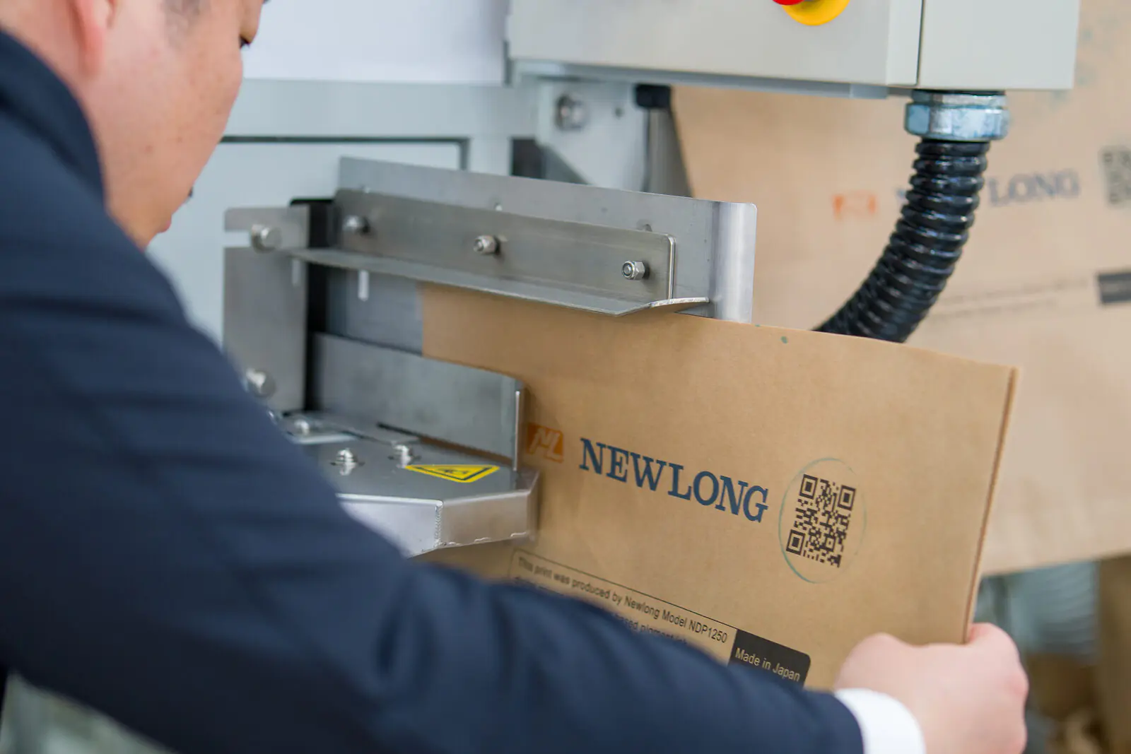 Newlong-branded paper bag detail with QR code